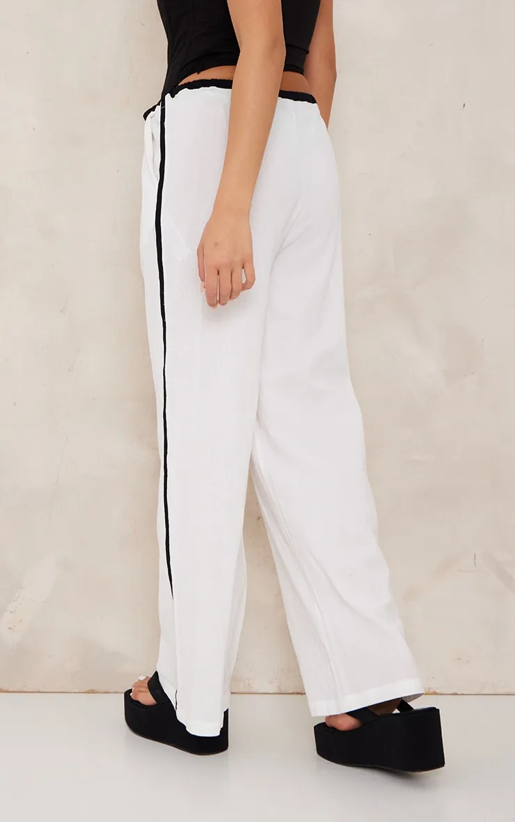 Pantalon en effet lin blanc à rayures contrastantes et cordons ajustables